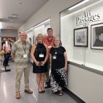 Gallery 2 - Artists from the Alamo Danville Artists' Society next to artwork by Nancy Shakes, Don Cresswell,  and Charles White at an Art Passages exhibit at the County Administration Building in Martinez, CA. Photo by ARTSCCC.