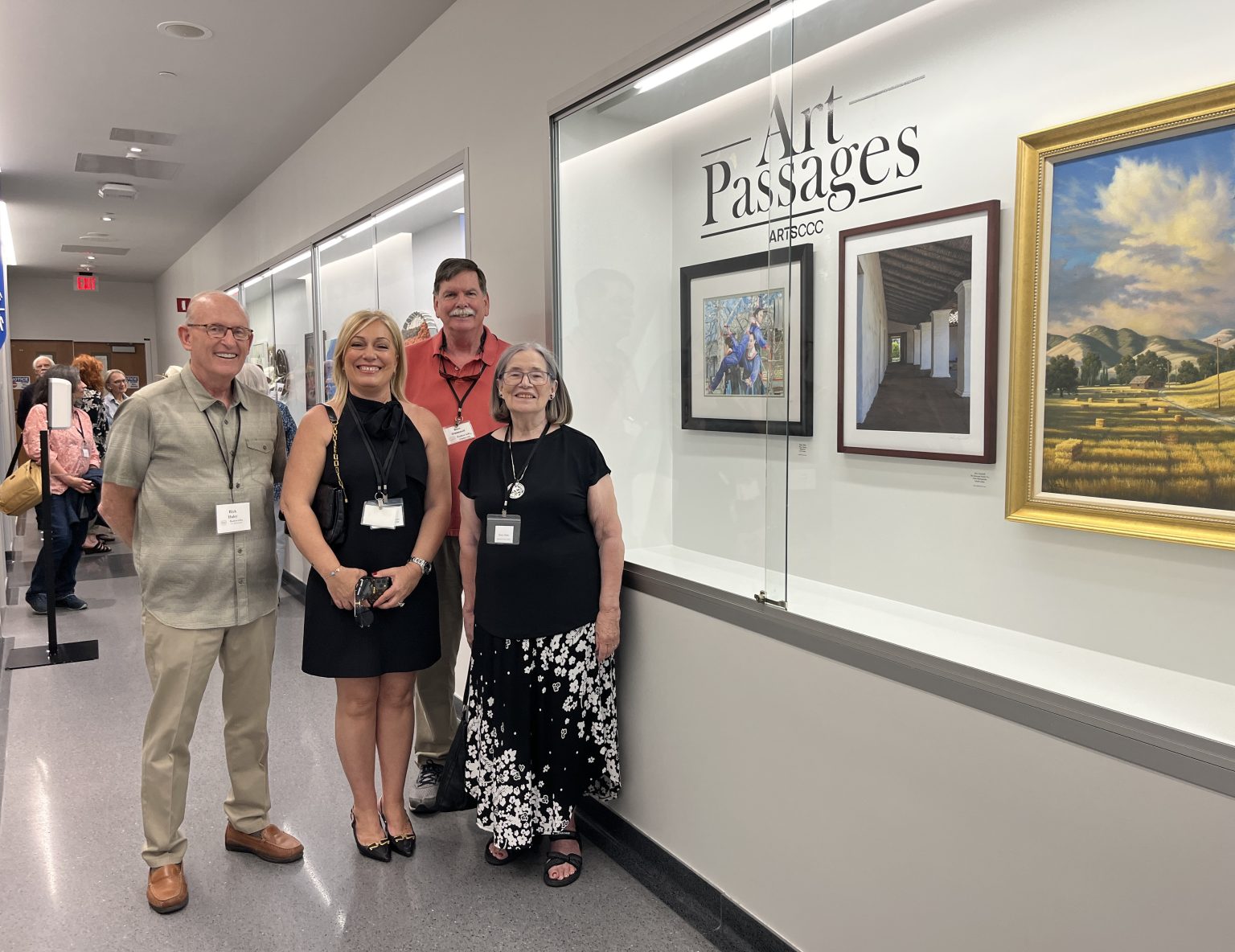 Gallery 2 - Artists from the Alamo Danville Artists' Society next to artwork by Nancy Shakes, Don Cresswell,  and Charles White at an Art Passages exhibit at the County Administration Building in Martinez, CA. Photo by ARTSCCC.