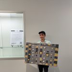 Gallery 1 - NIAD Gallery Programs Manager, Julio Rodriguez with artwork by Janay Futch at an Art Passages exhibit. Photo by ARTSCCC.