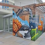 Gallery 1 - Exterior mural with chickadee, pelicans and flowers.