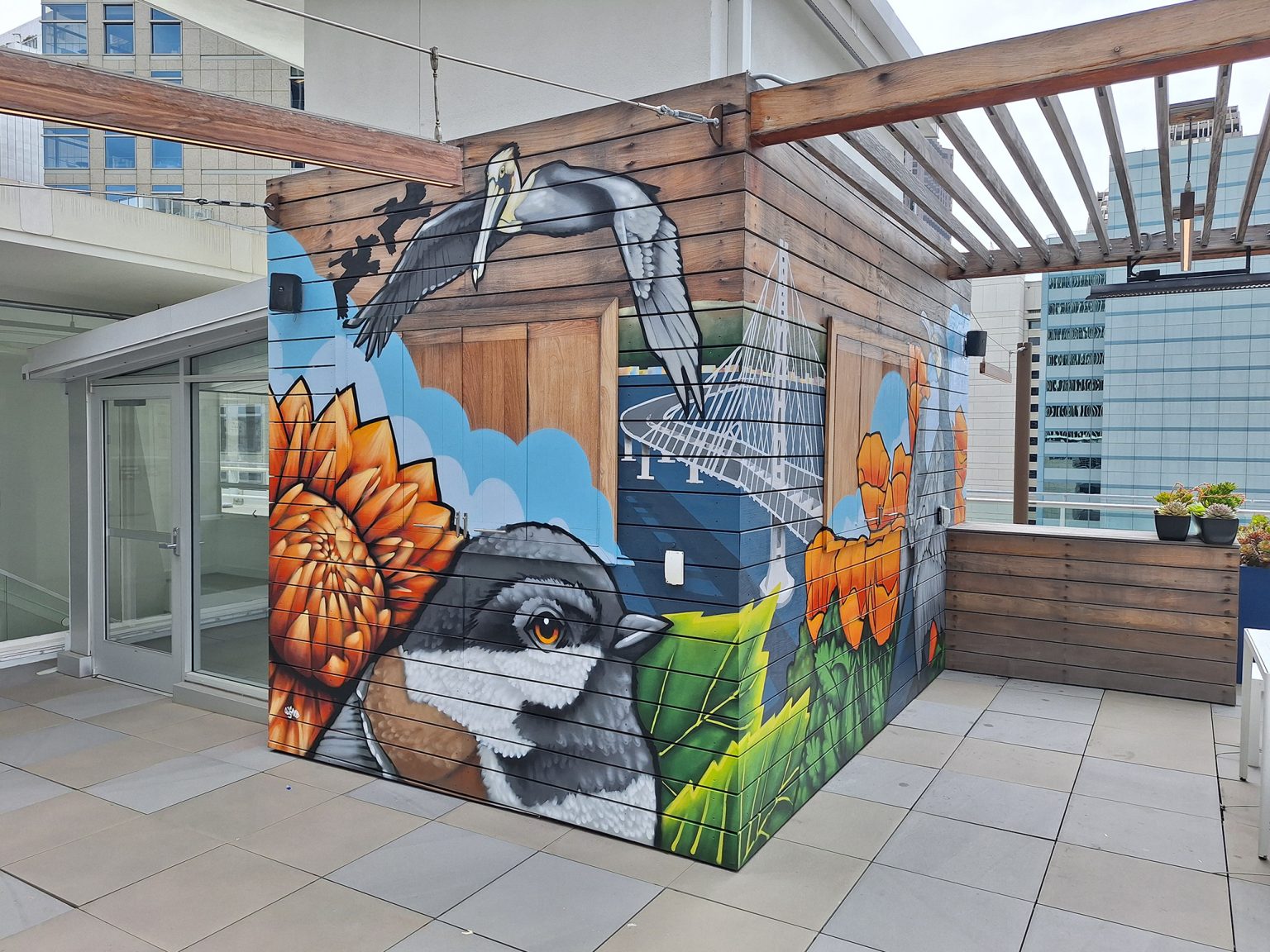 Gallery 1 - Exterior mural with chickadee, pelicans and flowers.