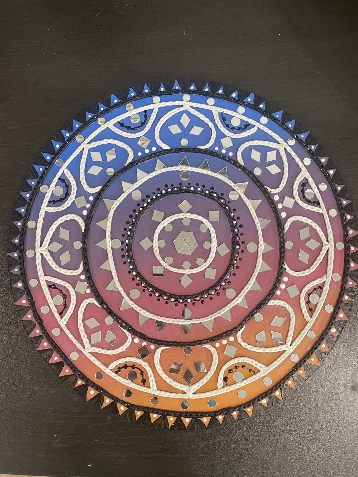 Gallery 1 - Round artwork with white curved lines. cool colors at the top and warm colors at the bottom.