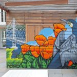 Gallery 2 - Exterior mural with cormorant bird, California poppy flowers and bay bridge.