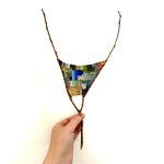 Gallery 2 - this is a tapestry weaving on a branch with abstract pattern.