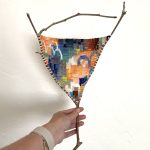 Gallery 3 - this is a tapestry weaving on a branch with abstract pattern.