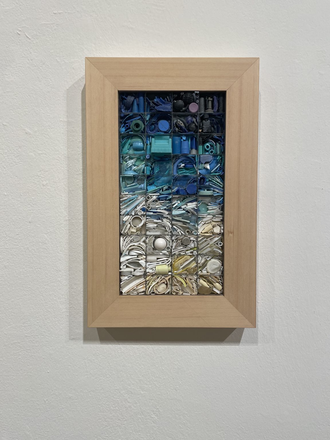 Gallery 5 - A plastic mosaic piece with the colors arranged from white at the bottom to dark blue and black 