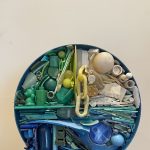 Gallery 6 - A circular mosaic piece made of found plastic in blues, greens, yellows and white
