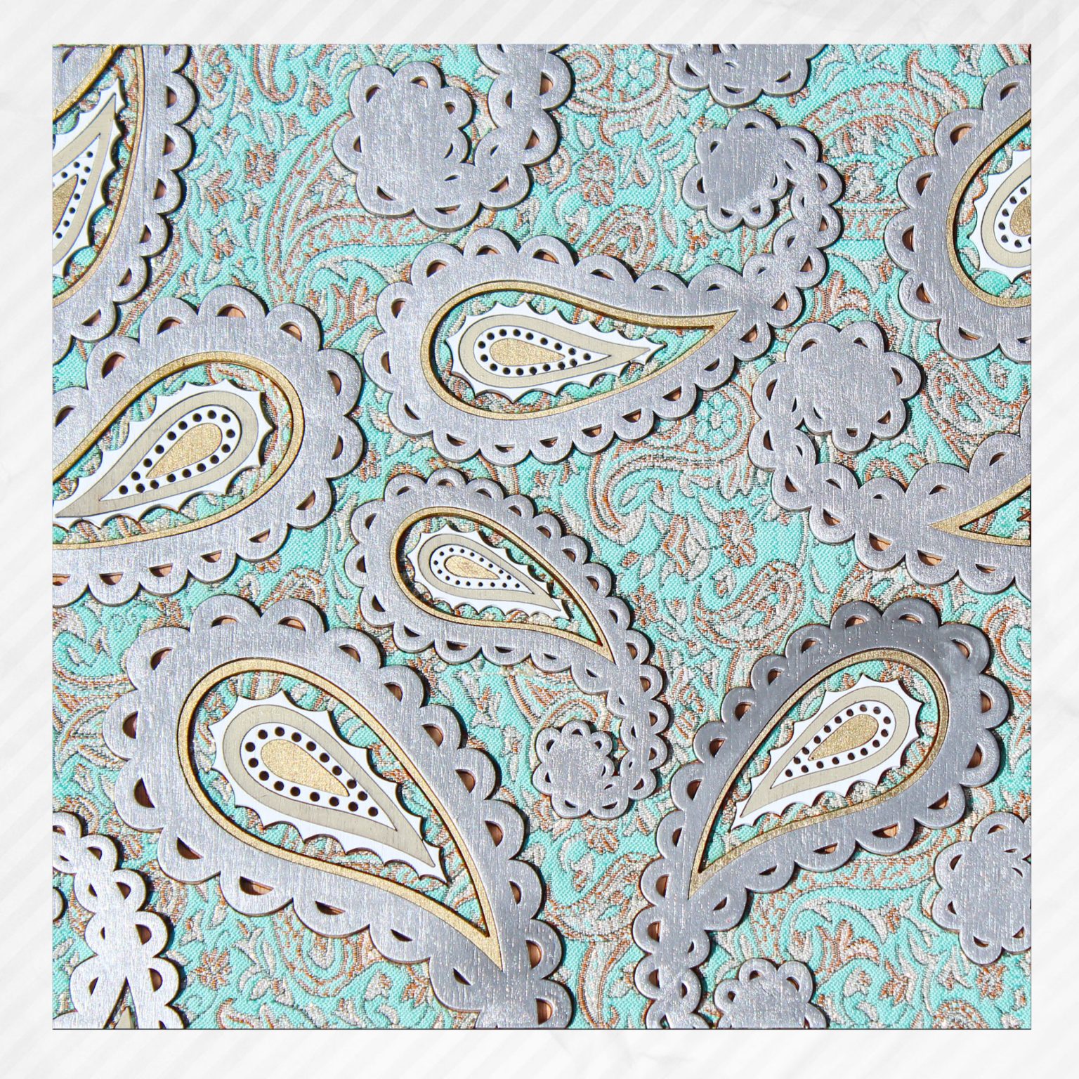 Gallery 8 - Silver paisley shaped handmade fabric wall-art on aqua colored background.