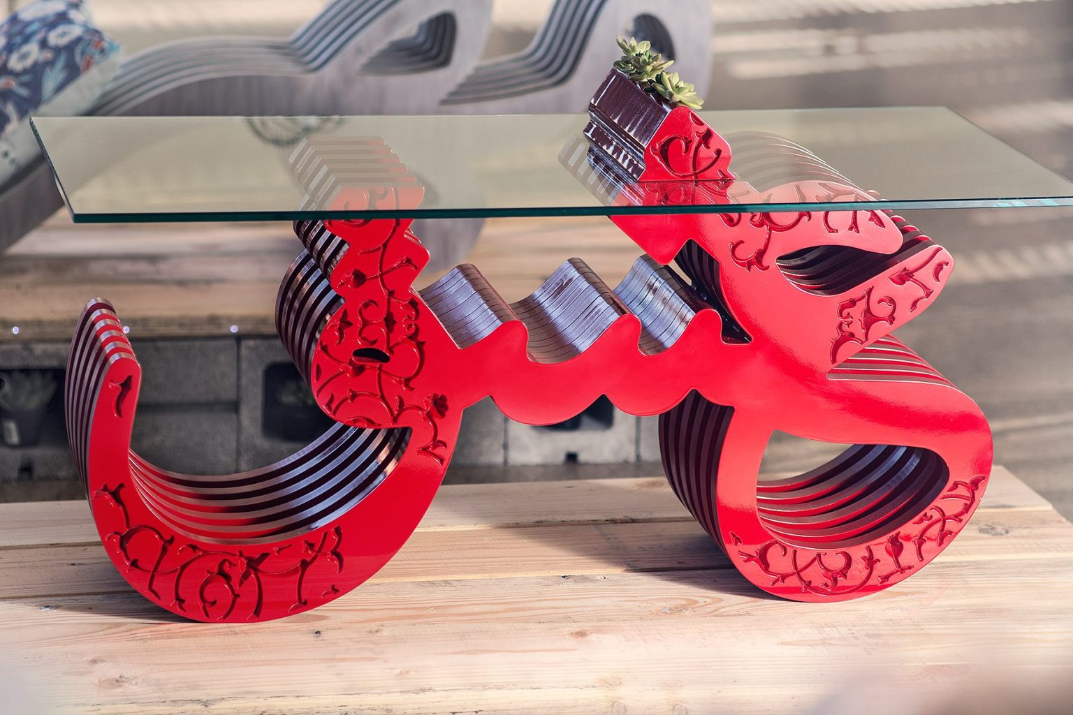 Gallery 9 - A glass coffee table with a red base in the form of the Persian word 