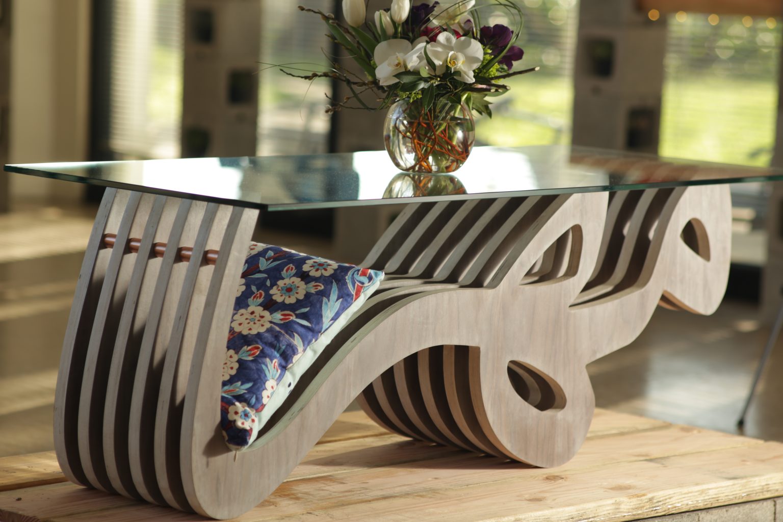 Gallery 10 - A glass coffee table with a silver base in the form of the Persian word 