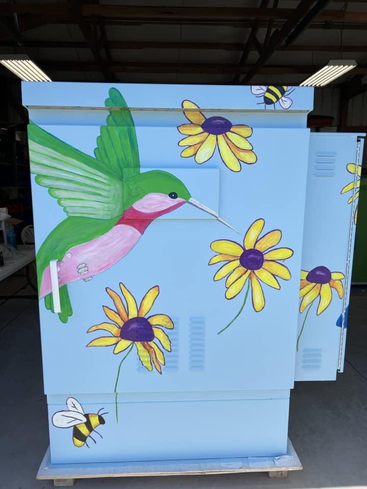 Gallery 2 - A painting of a humming green bird and sun flowers on Utility Box Art