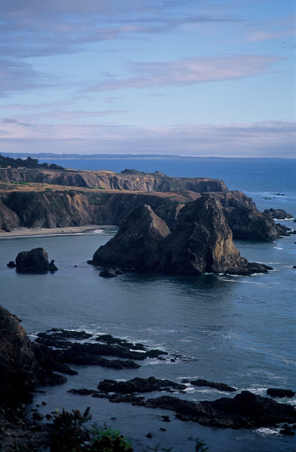 Gallery 6 - image of a shoreline with tall rock islands after sunset or before sunrise