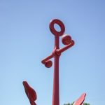 Gallery 1 - Low angle photo of a large red Anchor sculpture