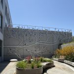 Gallery 1 - A 19-foot-high outdoor sculpture made of aluminum and illuminated with soft LED lights, featuring upward-reaching, branch-like forms inspired by the human nervous system and local plant life.