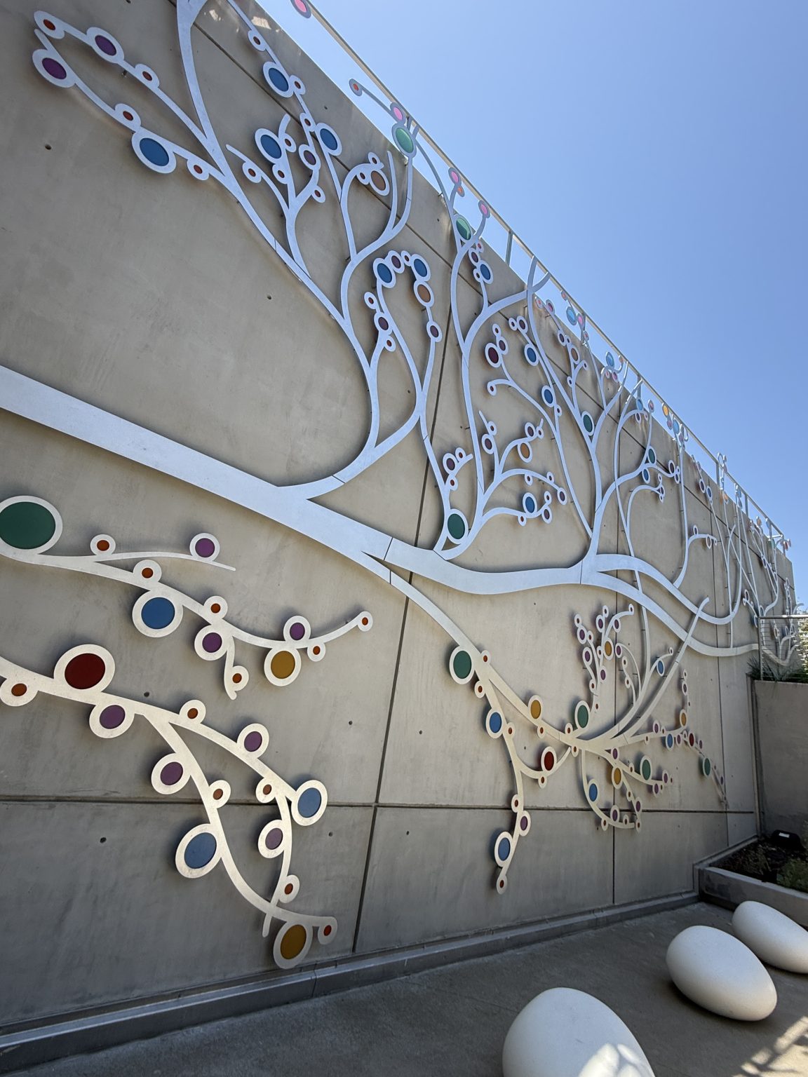Gallery 2 - A 19-foot-high outdoor sculpture made of aluminum and illuminated with soft LED lights, featuring upward-reaching, branch-like forms inspired by the human nervous system and local plant life.