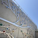 Gallery 2 - A 19-foot-high outdoor sculpture made of aluminum and illuminated with soft LED lights, featuring upward-reaching, branch-like forms inspired by the human nervous system and local plant life.
