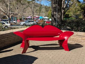 a red seat. made of repurposed steel propane tank