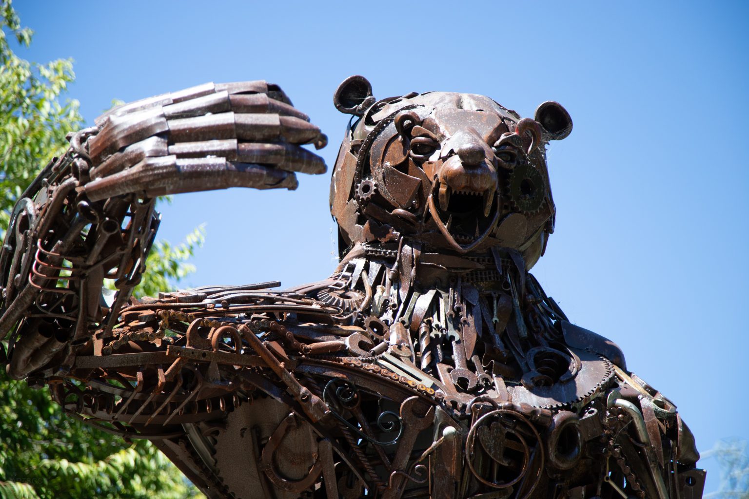 Gallery 1 - Image of a metal brown bear made of metal objects like gears and recycled equipment parts.