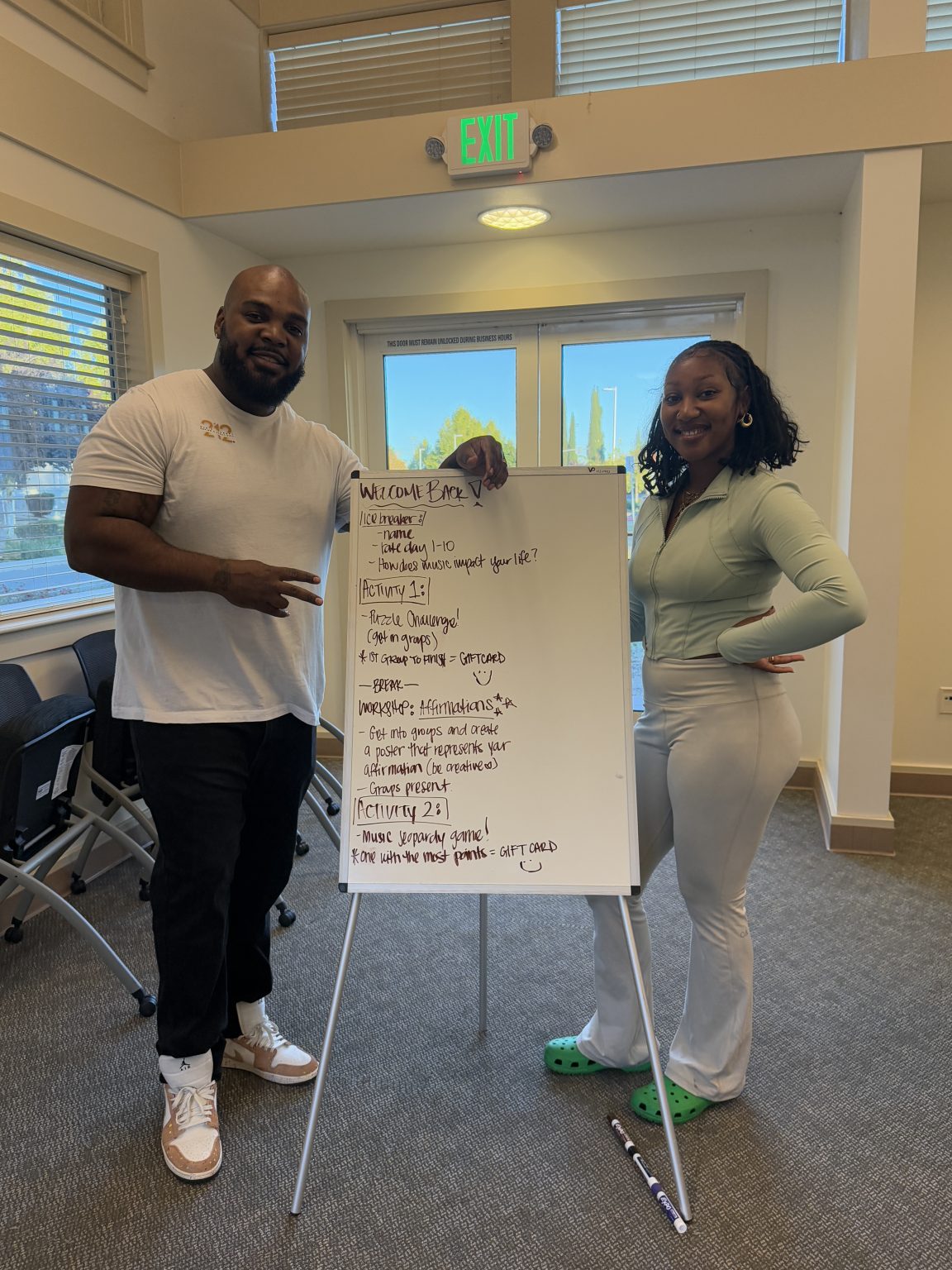 Gallery 1 - Tajanique Bell and Jeremy Phillip next to a white board at a “Youth Arts Connection” workshop at the Pittsburg Library.