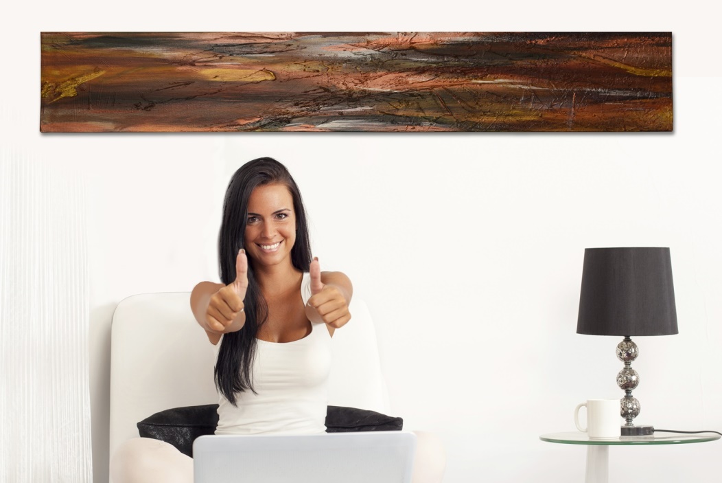 Gallery 3 - Smiling woman giving two thumbs up while sitting under a long, horizontal abstract painting with dark, earthy tones.