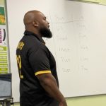 Gallery 3 - Jeremy Phillips standing in front of a white board during a “Poetry Series Program” workshop at Juvenile Hall in Martinez.