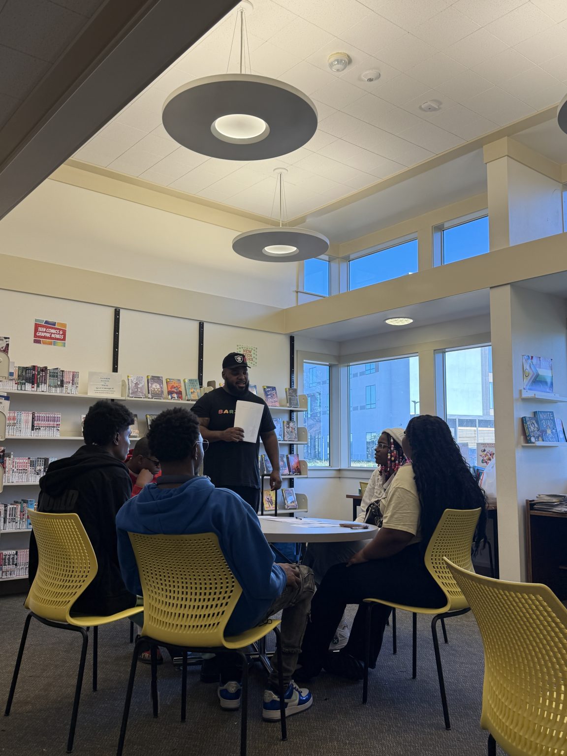 Gallery 4 - Jeremy Phillips leading a “Youth Arts Connection” workshop in front of sitting students at the Pittsburg Library.