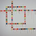 Gallery 5 - An abstract grid pattern made up of knitted squares.