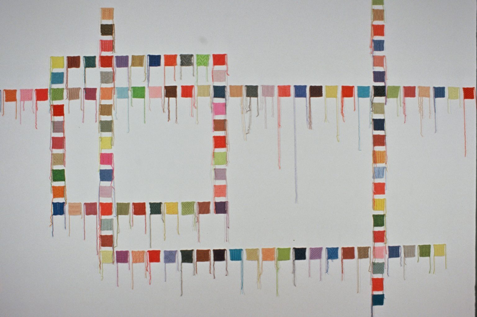 Gallery 5 - An abstract grid pattern made up of knitted squares.