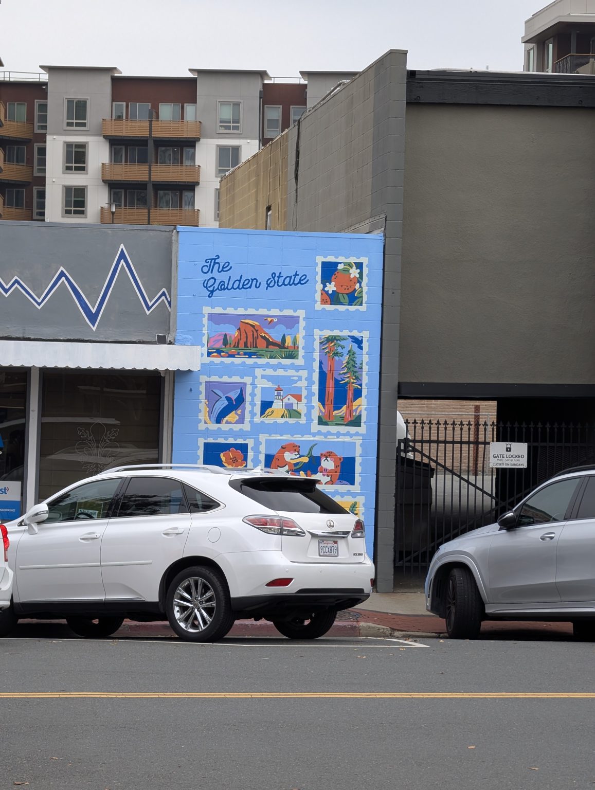 Gallery 1 - A light blue brick wall mural titled 
