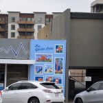Gallery 1 - A light blue brick wall mural titled 