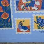 Gallery 2 - A light blue brick wall mural titled 