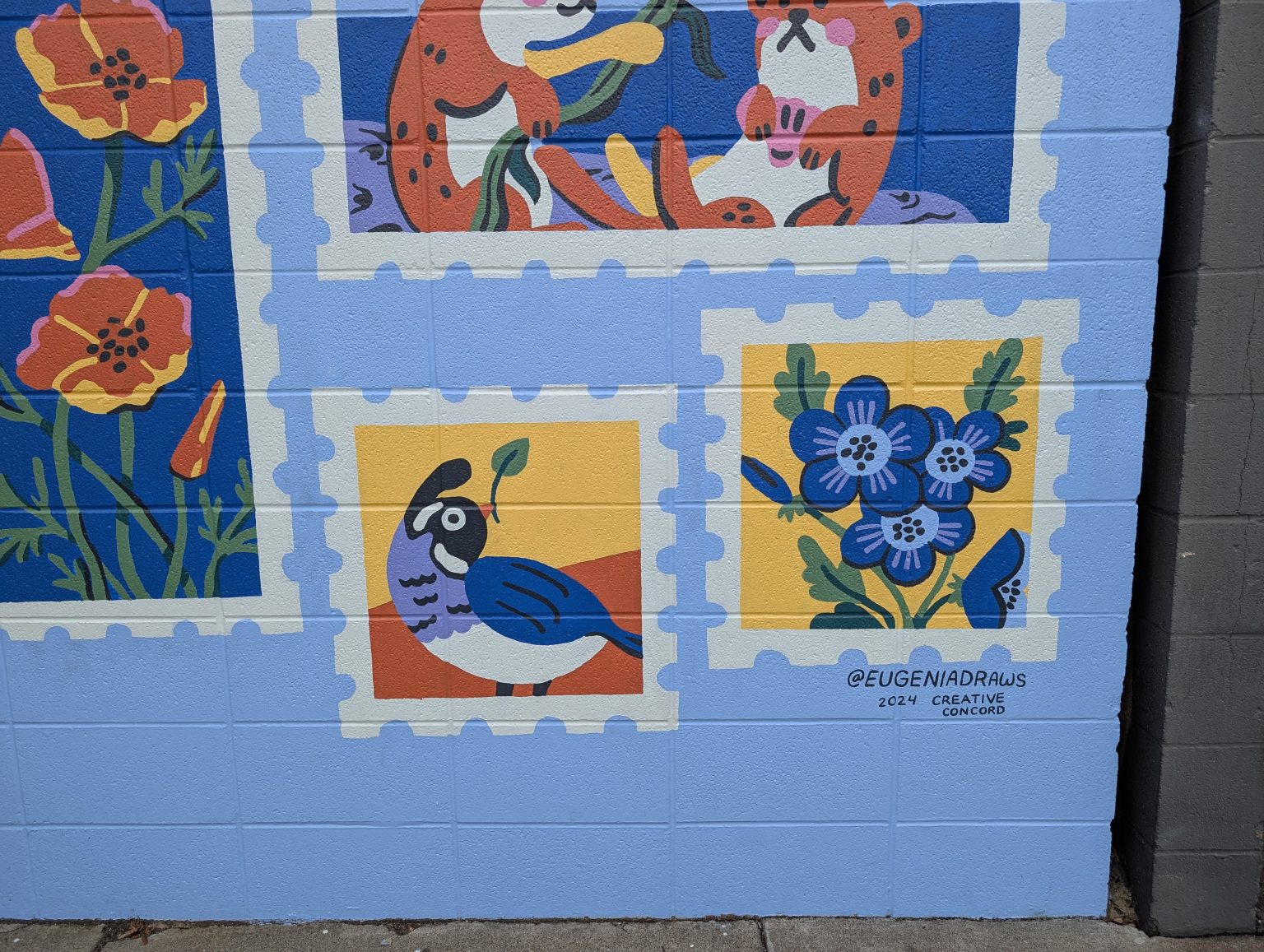 Gallery 2 - A light blue brick wall mural titled 