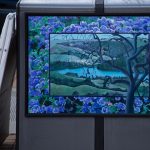 Gallery 1 - A utility box features a landscape painting of the San Pablo Reservoir viewed through the branches of a dark, twisting tree. The central image is framed by a dense border of vibrant purple hydrangeas, and a small plaque encourages viewers to find six hidden animals.