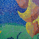 Gallery 1 - A colorful mosaic mural on a curved concrete wall displays the word 