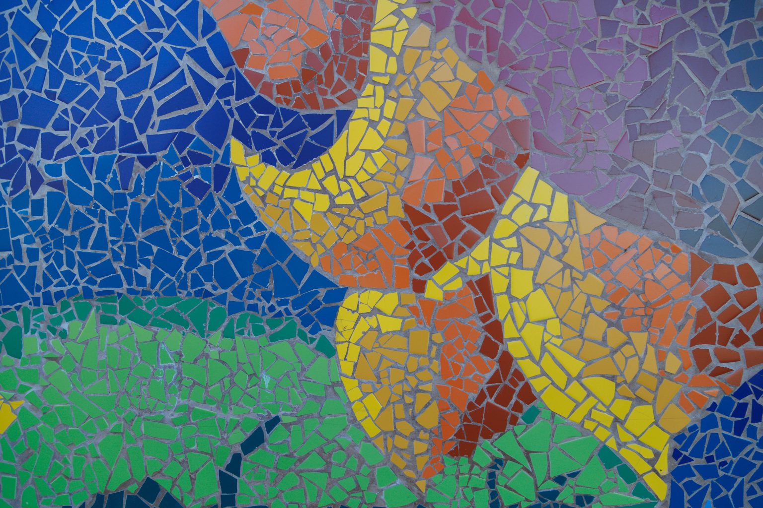 Gallery 1 - A colorful mosaic mural on a curved concrete wall displays the word 