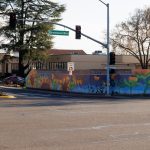 Gallery 6 - A colorful mosaic mural on a curved concrete wall displays the word 