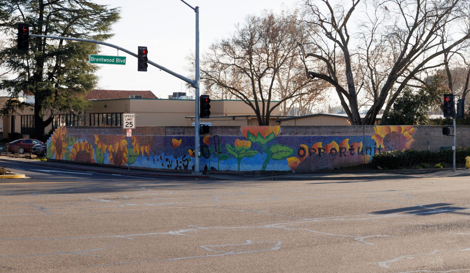 Gallery 6 - A colorful mosaic mural on a curved concrete wall displays the word 