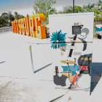 Gallery 1 - A series of three utility boxes painted with colorful murals. One box shows a classic black car with 