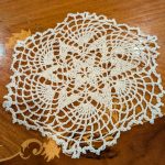 Gallery 3 - White crocheted doily with a star pattern