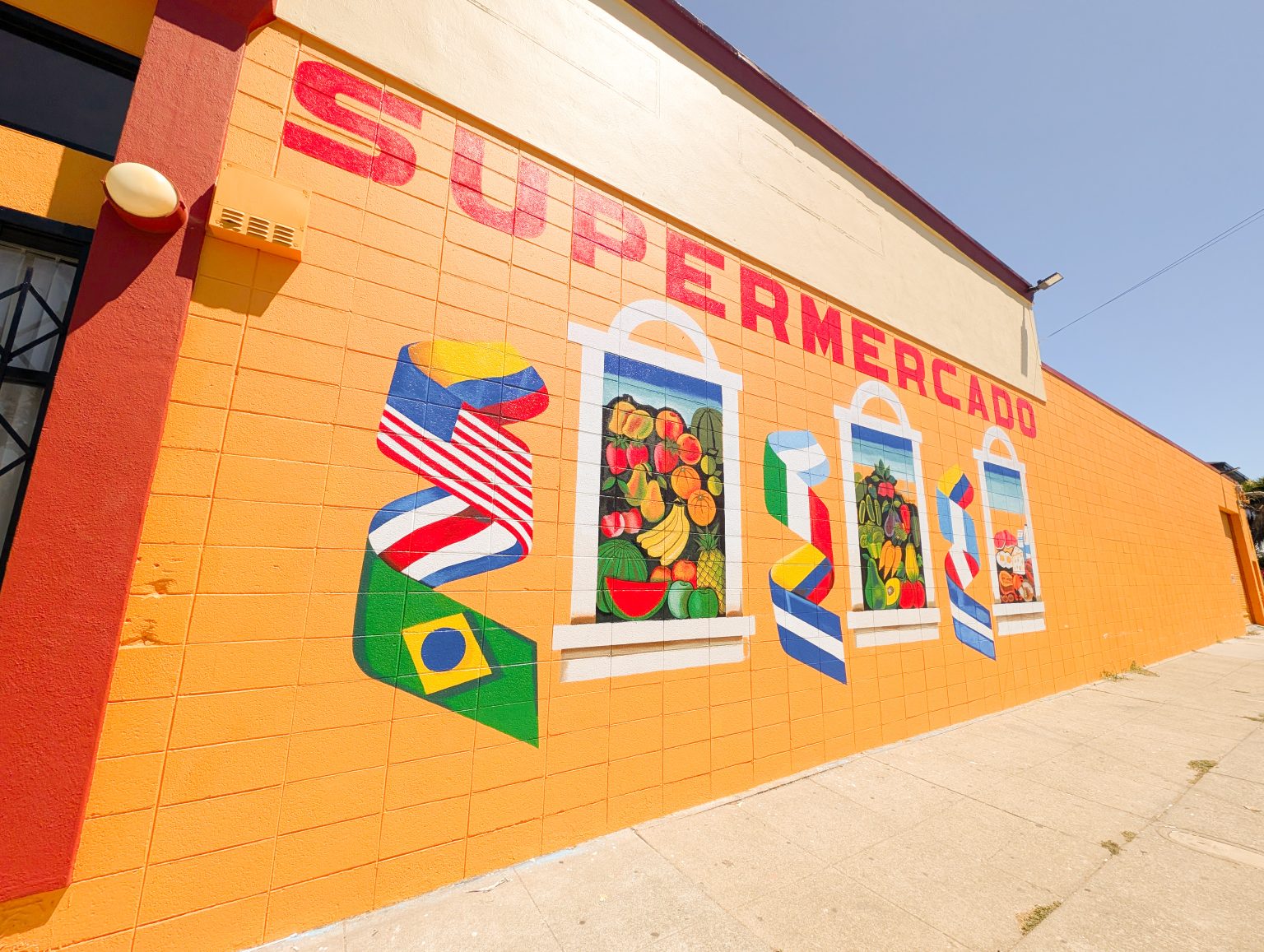 Gallery 3 - A painted mural on an orange cinder block wall displays the word 