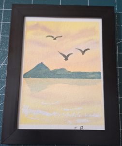 Afterglow, a watercolor seascape featuring a soft yellow and peach sunset, distant blue-green mountains, three birds in flight, and gentle waves along the shore.